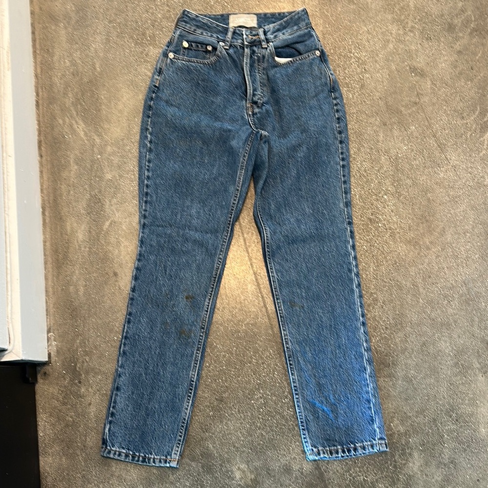 Denim, size 23, it has a small stain but that could be removed. Used once